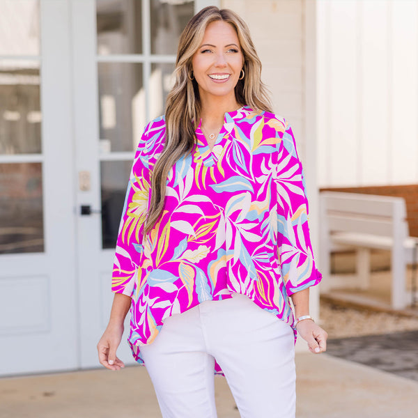 Plus Size magenta floral print top with a V-neckline, three-quarter sleeves, and a relaxed fit.