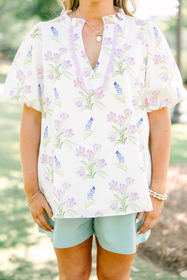 Plus Size cream floral top with puff sleeves, ric rac V-neckline, and light green shorts.