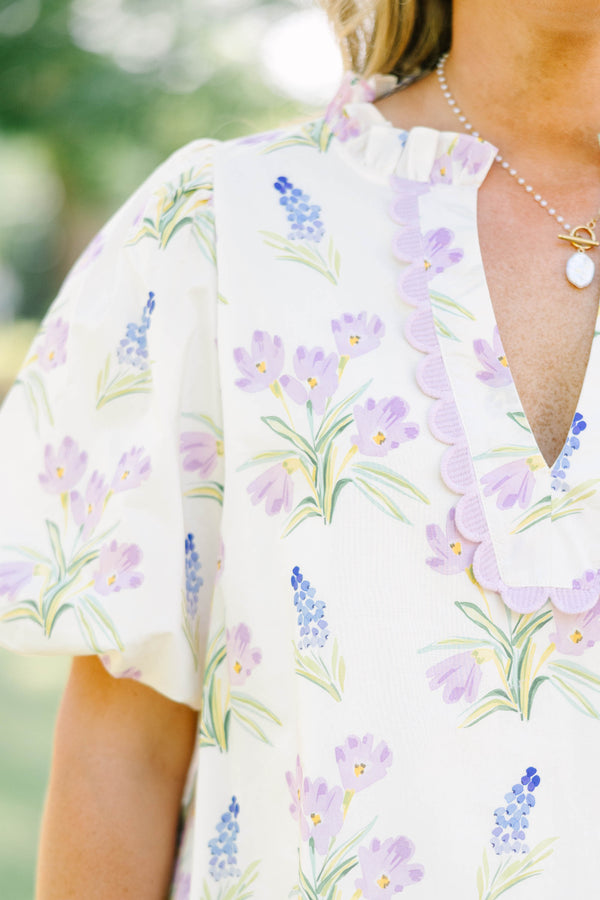 Plus Size cream floral top with puff sleeves, ric rac V-neckline, and light green shorts.