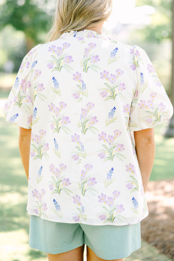 Plus Size cream floral top with puff sleeves, ric rac V-neckline, and light green shorts.