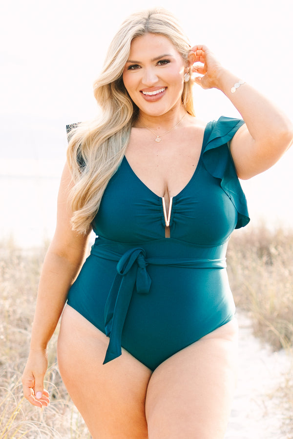 Chic Soul plus size clothing, teal one piece with flutter sleeves a belt that ties around the waist as well as a deep v-neckline that has a gold v detail along the v-neckline 