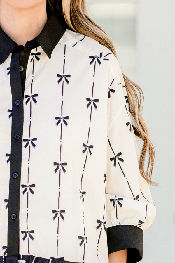 Chic Soul plus size clothing, quarter-long-sleeve beige and black bow collared and button-down top with a pocket on the bodice and a subtle ruffling along the hem 