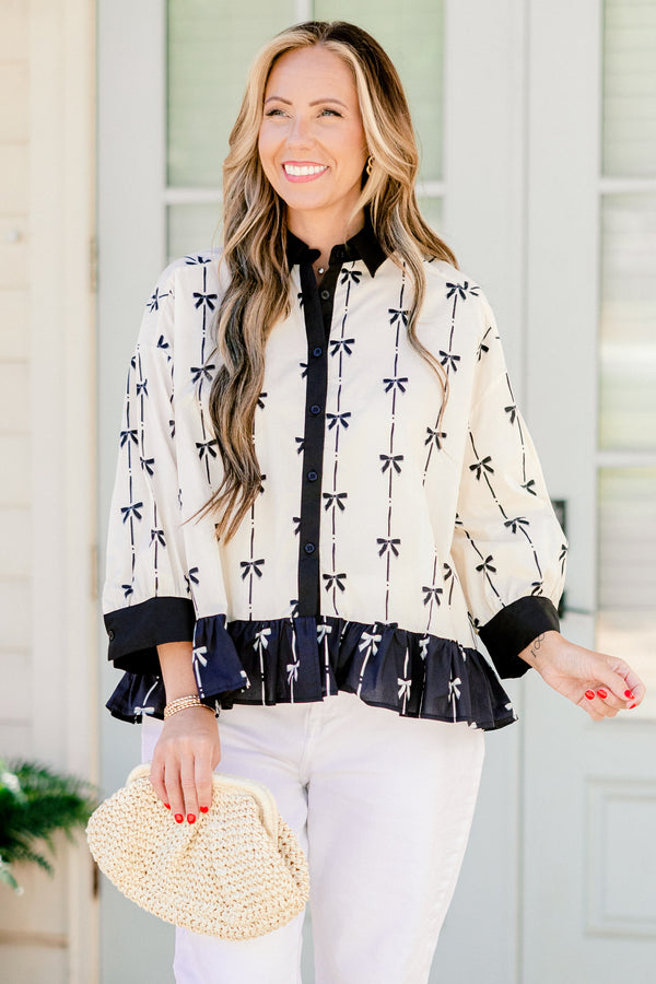 Chic Soul plus size clothing, quarter-long-sleeve beige and black bow collared and button-down top with a pocket on the bodice and a subtle ruffling along the hem 
