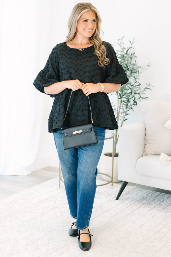 Plus size black textured Swiss dot top with a flowy tiered silhouette and ruffle sleeves.