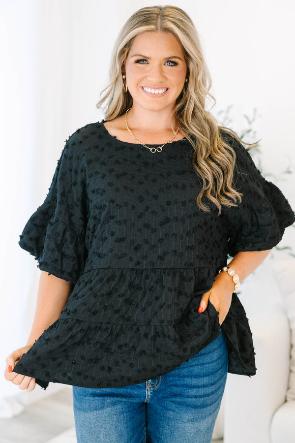 Plus size black textured Swiss dot top with a flowy tiered silhouette and ruffle sleeves.