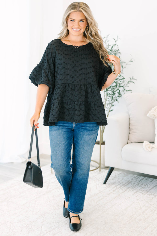 Plus size black textured Swiss dot top with a flowy tiered silhouette and ruffle sleeves.