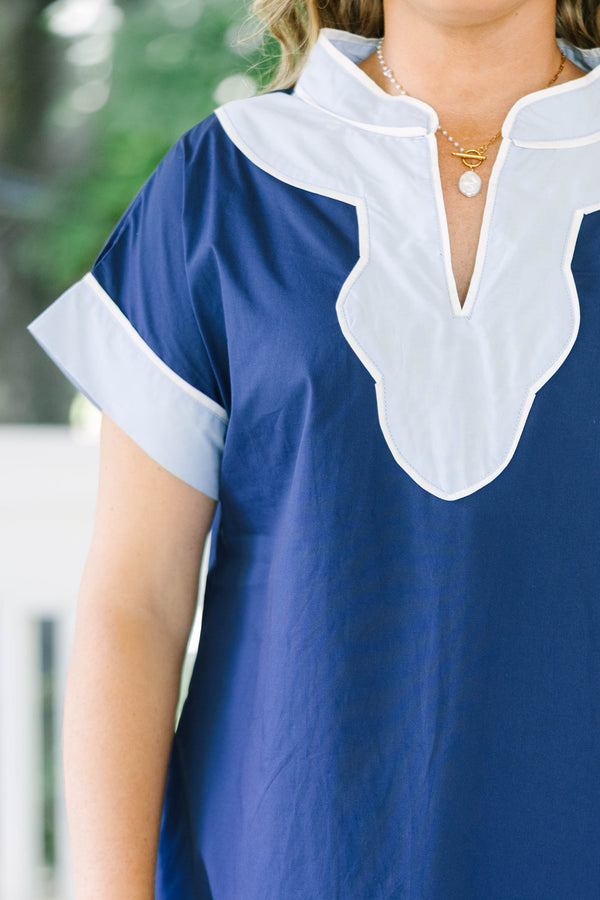 Plus Size blue shift dress with white trim on the V-neckline, short sleeves, and hem.