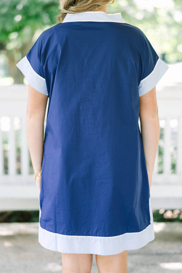Plus Size blue shift dress with white trim on the V-neckline, short sleeves, and hem.