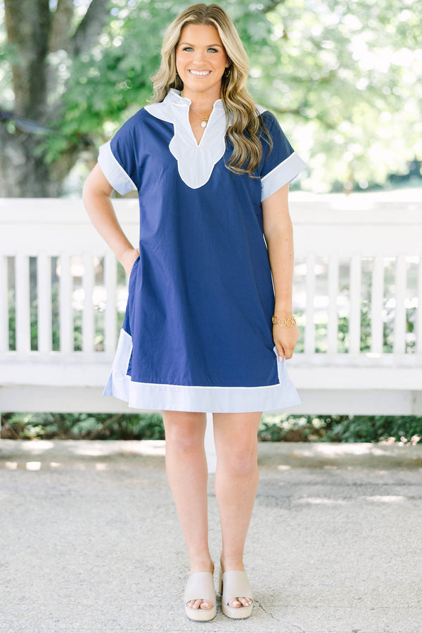 Plus Size blue shift dress with white trim on the V-neckline, short sleeves, and hem.