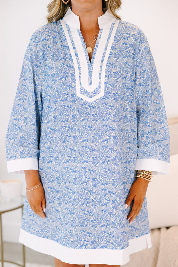 Plus Size blue and white floral tunic dress with a white-trimmed V-neckline and long sleeves.