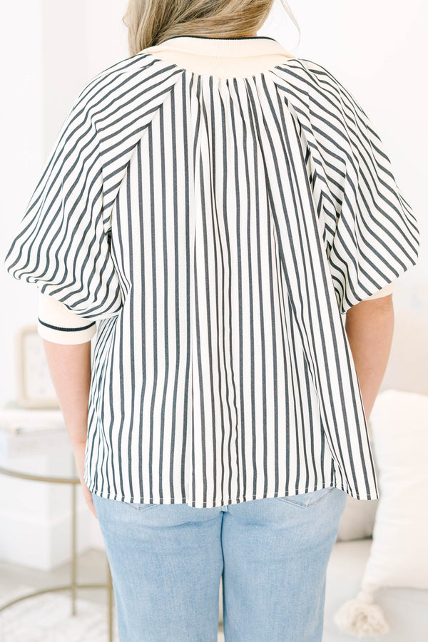 Plus size black and white striped top with a flowy fit, quarter-zip neckline, and ribbed cuffs.