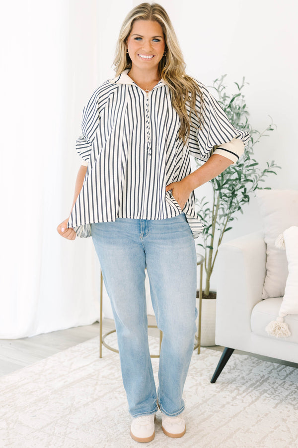 Plus size black and white striped top with a flowy fit, quarter-zip neckline, and ribbed cuffs.