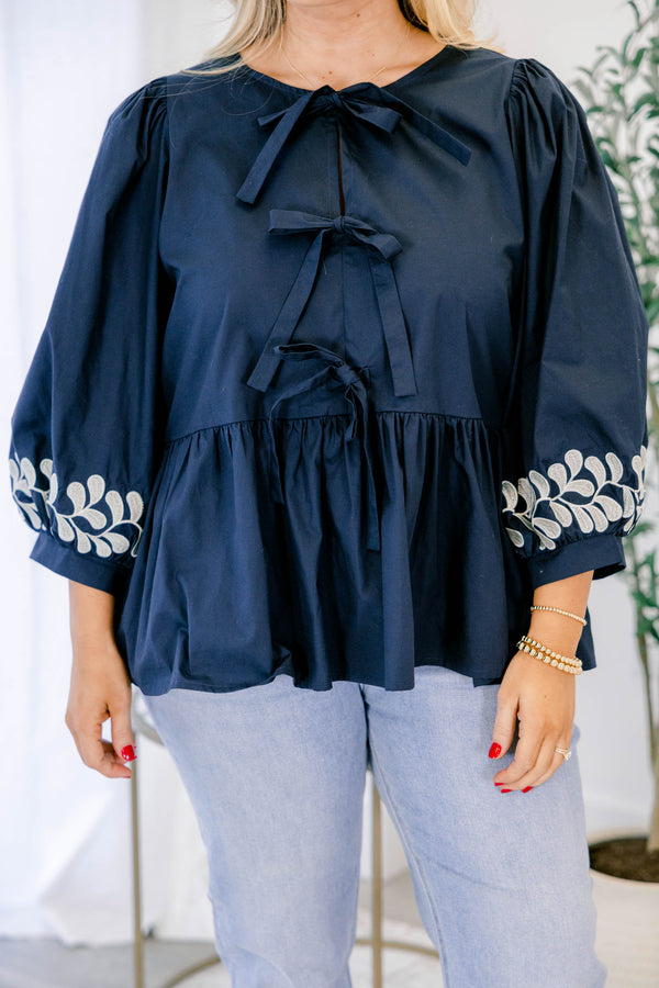 Chic Soul plus size clothing, navy top with floral details at the end of each half sleeve as well as three bows going down the center of the top 