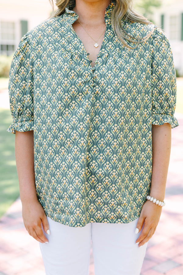 Plus Size green floral print top with puff sleeves, a ruffled collar, and a button-down neckline.