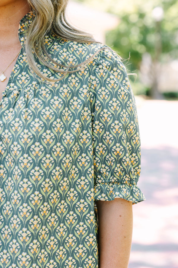 Plus Size green floral print top with puff sleeves, a ruffled collar, and a button-down neckline.