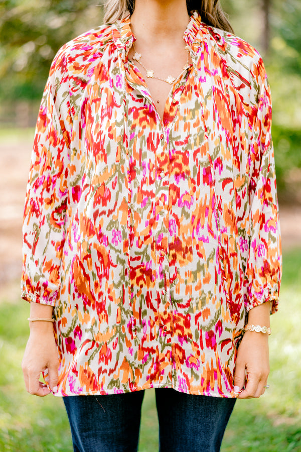 Chic Soul plus size clothing, ivory long bubble sleeve top with rust, orange, and pink abstract pattern and two ties at the collar