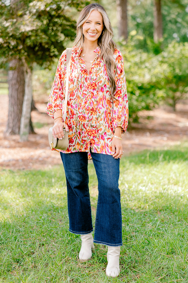 Chic Soul plus size clothing, ivory long bubble sleeve top with rust, orange, and pink abstract pattern and two ties at the collar