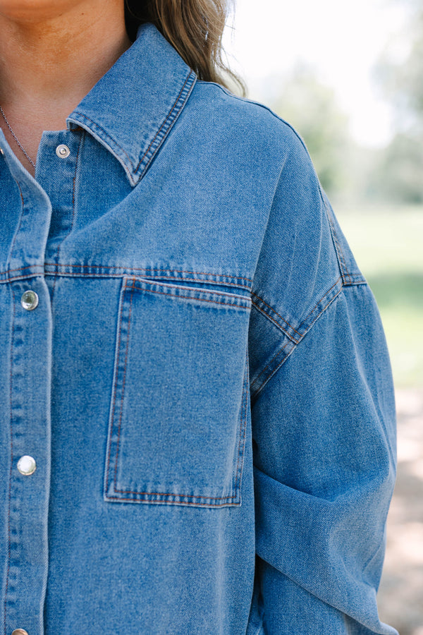 Plus size denim jacket with a relaxed fit, button-down front, and chest pockets.