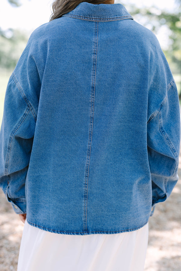 Plus size denim jacket with a relaxed fit, button-down front, and chest pockets.