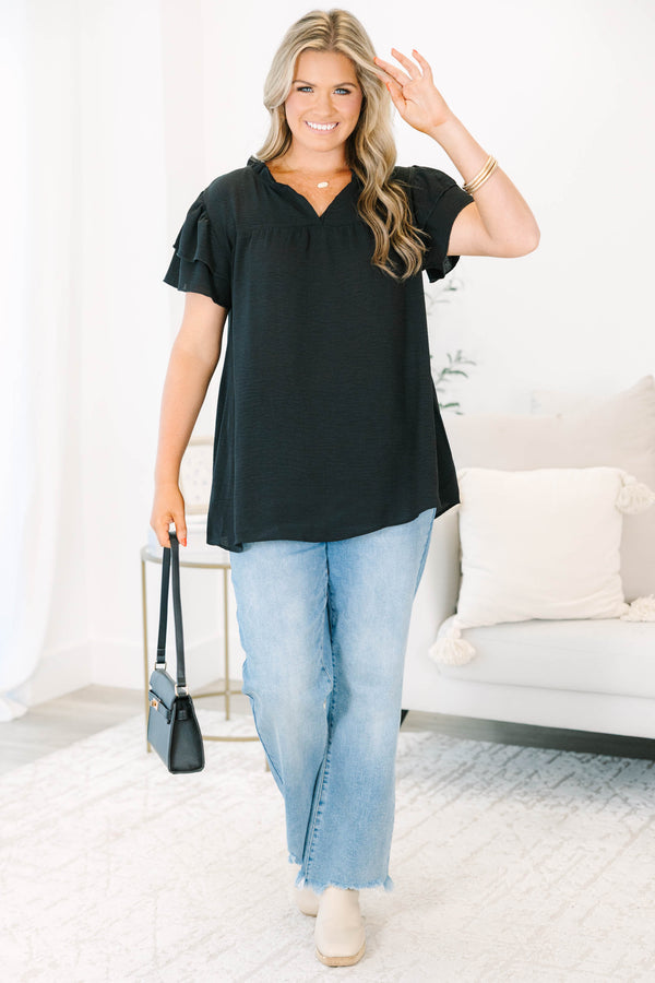 Plus Size black short sleeve top with tiered ruffle sleeves, a v-neckline, and a relaxed fit.