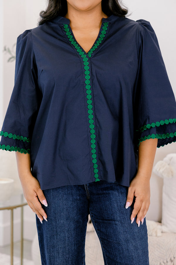 Chic Soul plus size clothing, Navy top with half bell sleeves, v-neckline, along with green polka dot details on the sleeves, neckline, and going down the center of the shirt 
