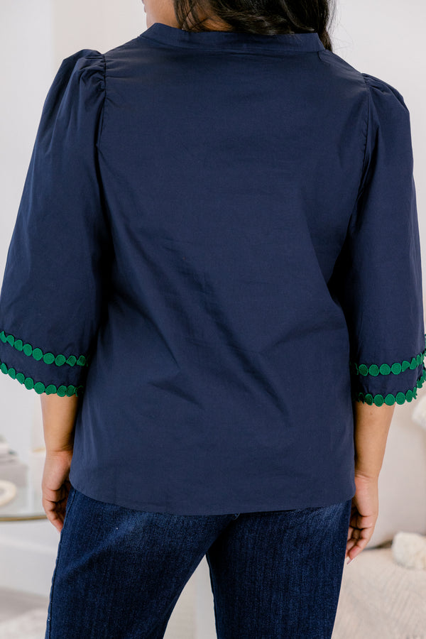Chic Soul plus size clothing, Navy top with half bell sleeves, v-neckline, along with green polka dot details on the sleeves, neckline, and going down the center of the shirt 