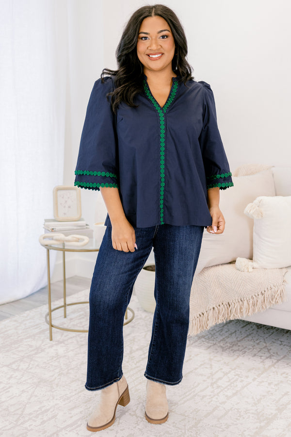 Chic Soul plus size clothing, Navy top with half bell sleeves, v-neckline, along with green polka dot details on the sleeves, neckline, and going down the center of the shirt 