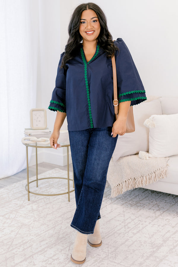 Chic Soul plus size clothing, Navy top with half bell sleeves, v-neckline, along with green polka dot details on the sleeves, neckline, and going down the center of the shirt 