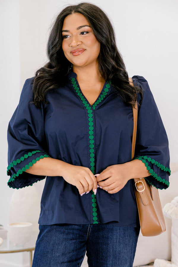Chic Soul plus size clothing, Navy top with half bell sleeves, v-neckline, along with green polka dot details on the sleeves, neckline, and going down the center of the shirt 