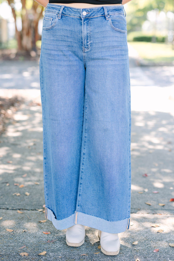 Plus Size medium wash wide leg jeans with a high waist and raw-edge cuffed hems.