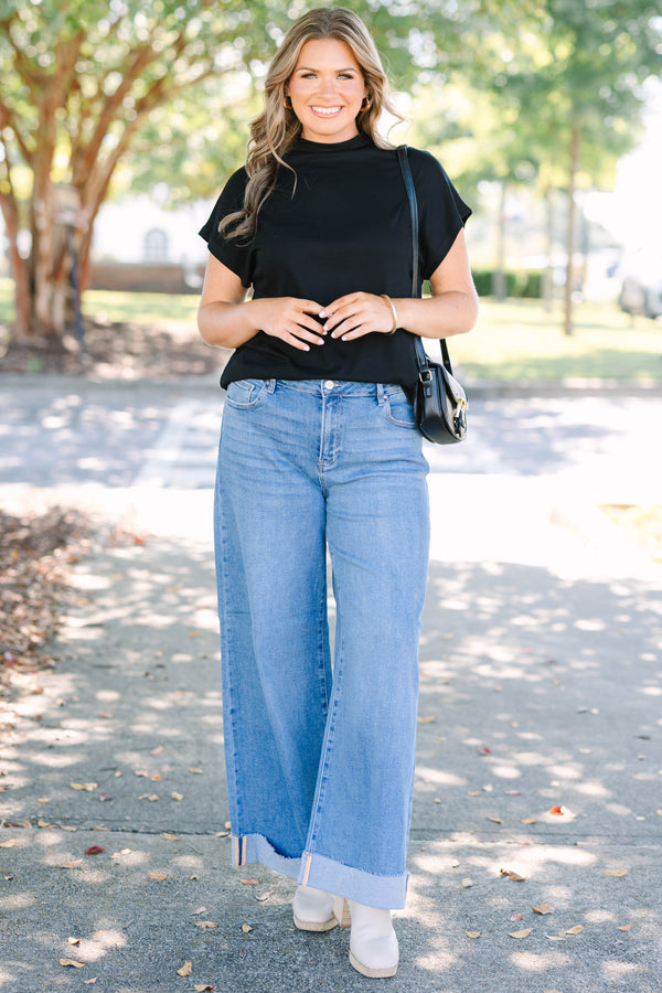 Plus Size medium wash wide leg jeans with a high waist and raw-edge cuffed hems.