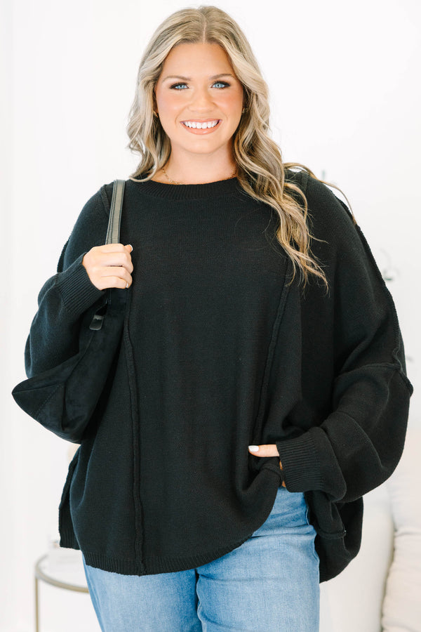 Plus Size black oversized knit sweater with a crew neckline, drop shoulders, and seam detailing.