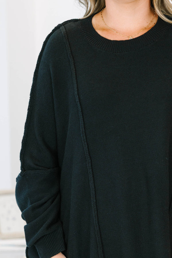 Plus Size black oversized knit sweater with a crew neckline, drop shoulders, and seam detailing.