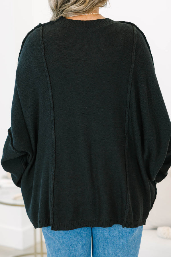 Plus Size black oversized knit sweater with a crew neckline, drop shoulders, and seam detailing.