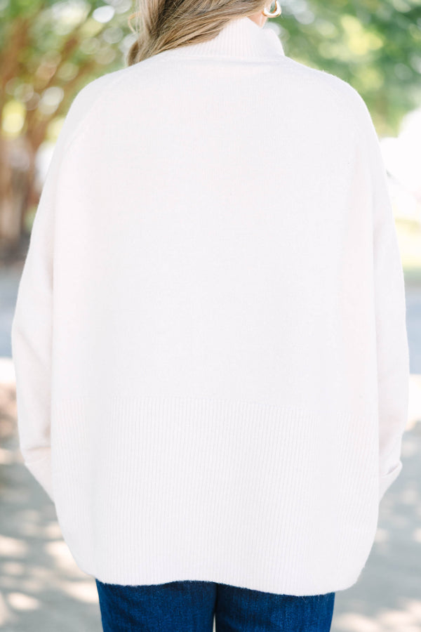 Plus size beige oversized mock neck sweater with a cozy, relaxed fit and ribbed texture.
