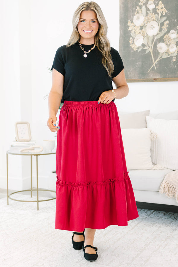 Plus size red midi skirt with a smocked waist and flowy ruffled hem in a soft polyester fabric.
