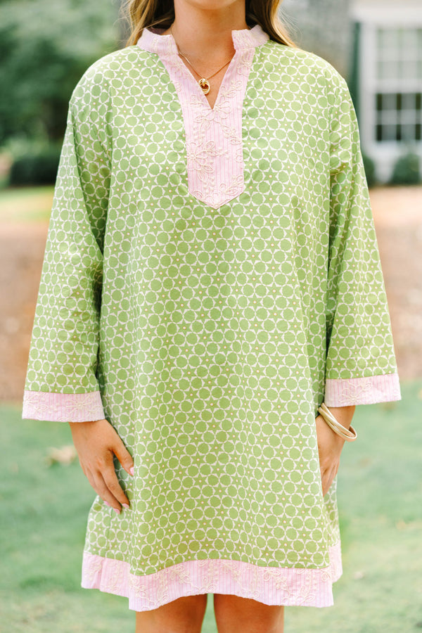 Plus size olive green geometric print tunic dress with pink embroidered trim and side pockets.