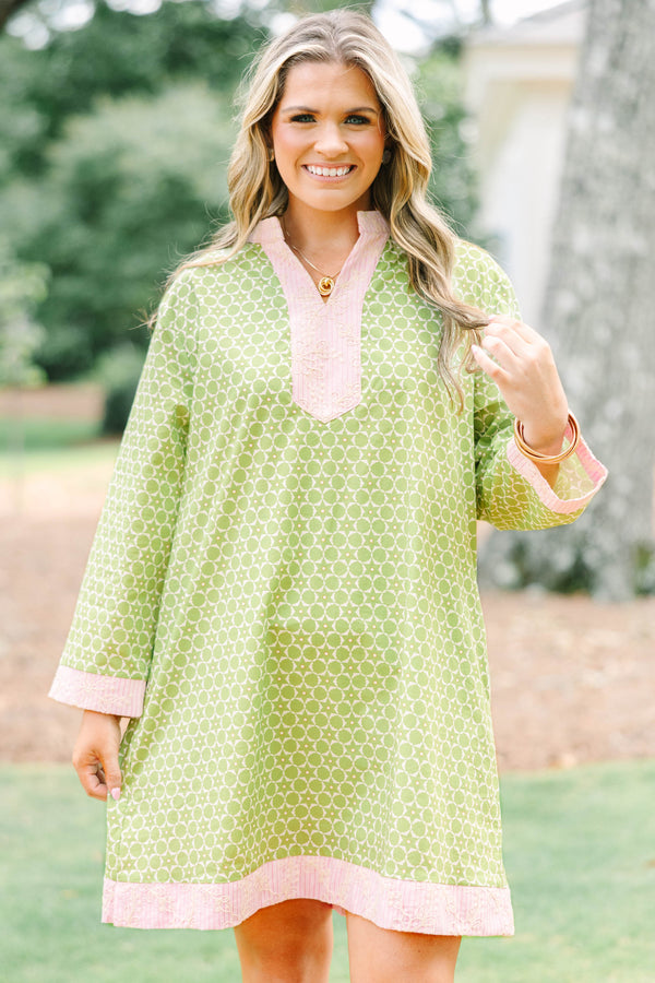 Plus size olive green geometric print tunic dress with pink embroidered trim and side pockets.