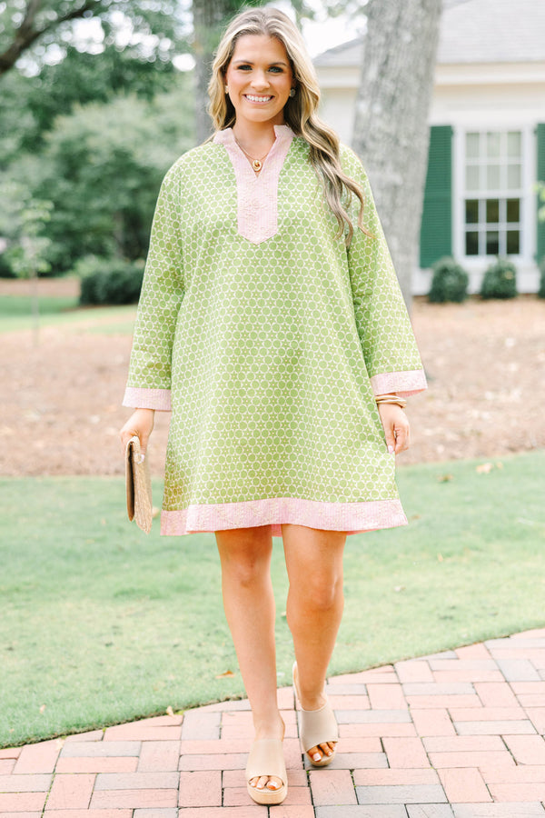 Plus size olive green geometric print tunic dress with pink embroidered trim and side pockets.