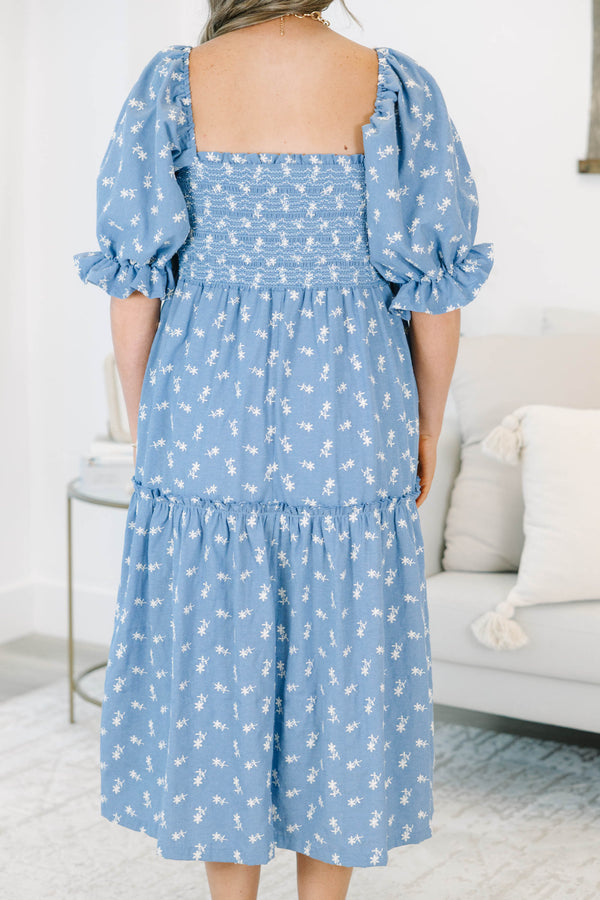 Plus size blue floral midi dress with a smocked bodice, puff sleeves, and a flowy tiered skirt.