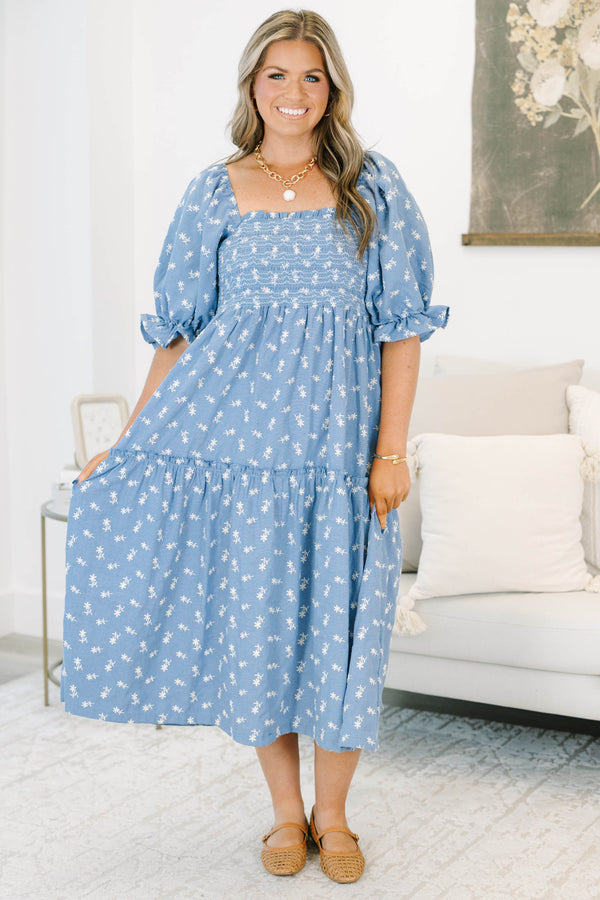 Plus size blue floral midi dress with a smocked bodice, puff sleeves, and a flowy tiered skirt.
