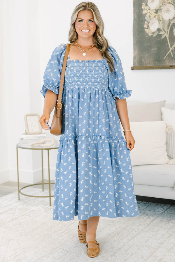 Plus size blue floral midi dress with a smocked bodice, puff sleeves, and a flowy tiered skirt.