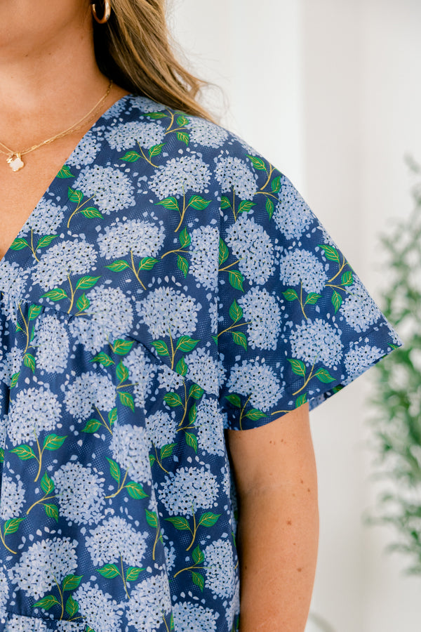 Chic Soul plus size clothing, navy blue short sleeve tiered babydoll top with v neckline and light blue hydrangeas on it
