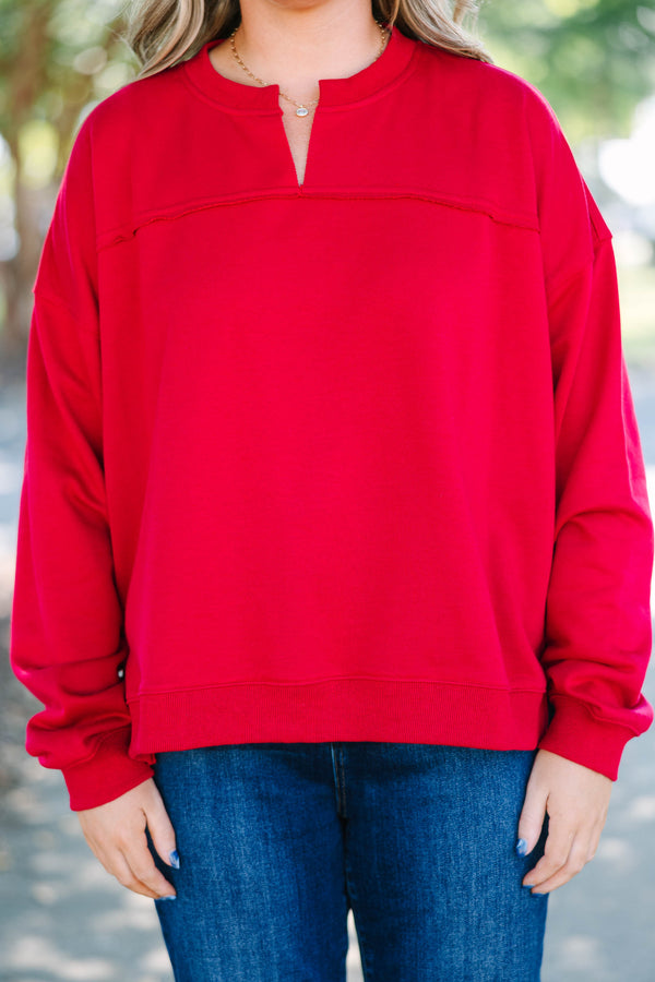 Plus Size crimson tunic sweatshirt with a split v-neckline, dropped shoulders, and raw seam details.