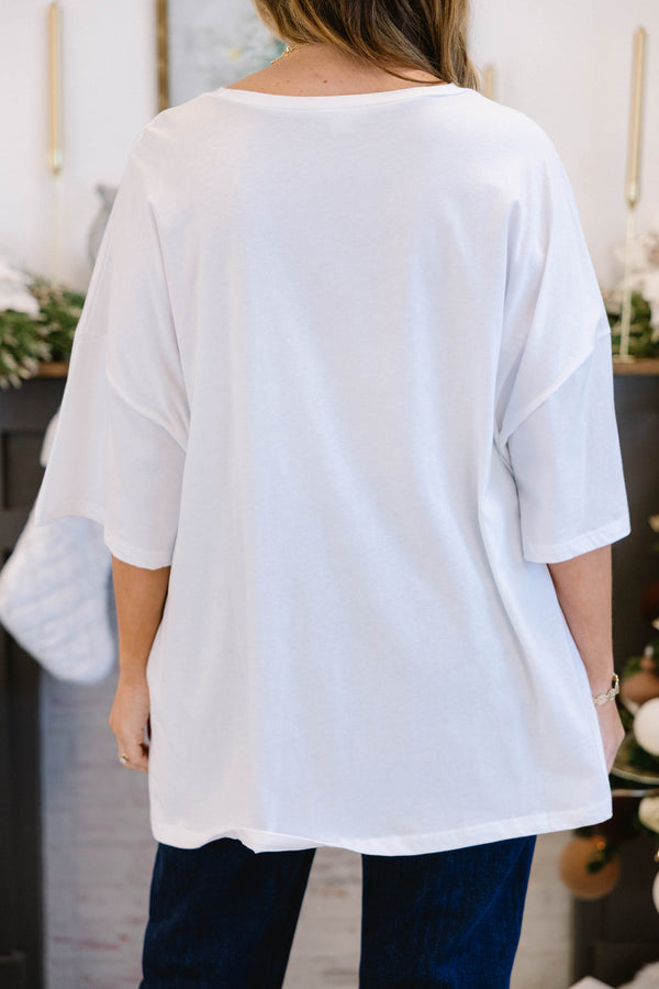 Chic Soul plus size clothing, white short sleeve boyfriend tee with “Holly Jolly” text in the middle with green and red holiday pattern on the inside and stars and snowflakes surrounding it