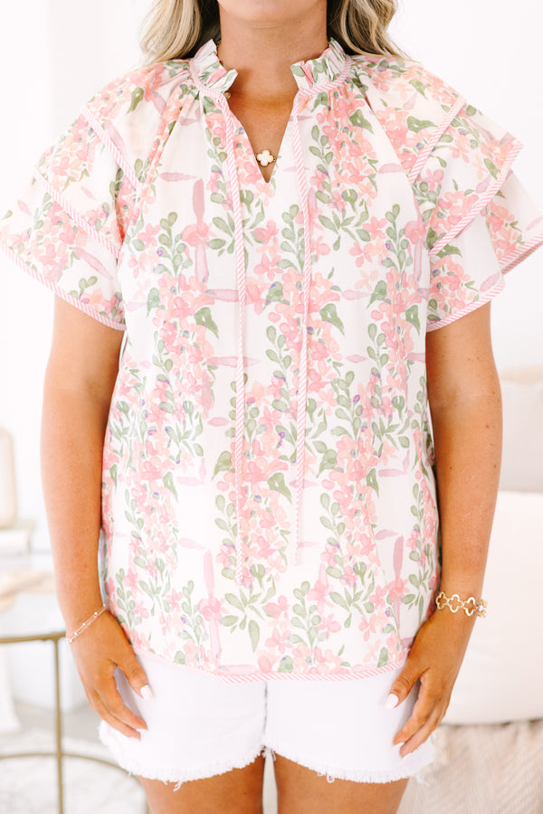 Plus Size pink and green floral print top with ruffled short sleeves and a tie-neckline.
