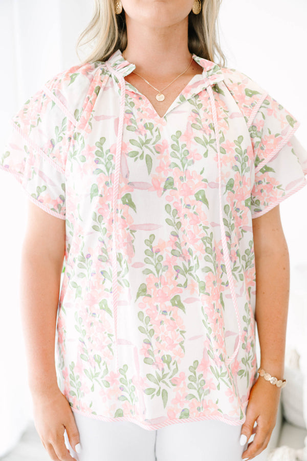 Plus Size pink and green floral print top with ruffled short sleeves and a tie-neckline.