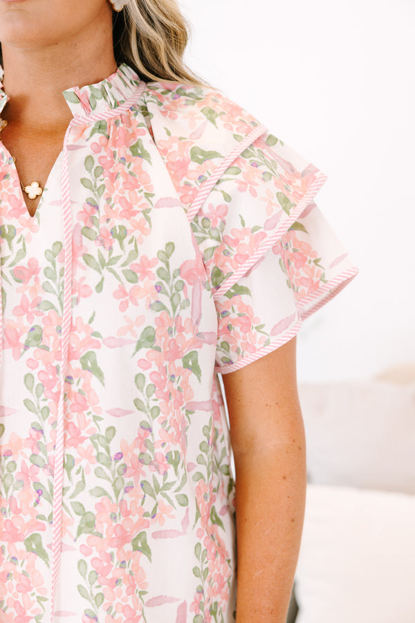 Plus Size pink and green floral print top with ruffled short sleeves and a tie-neckline.