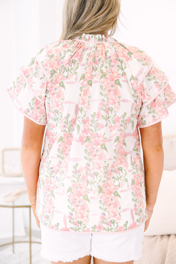 Plus Size pink and green floral print top with ruffled short sleeves and a tie-neckline.