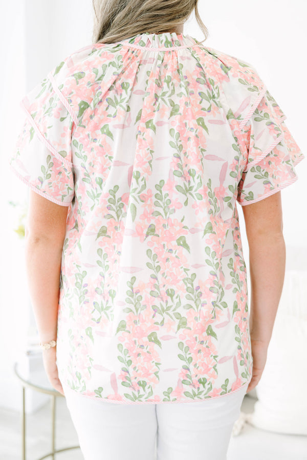 Plus Size pink and green floral print top with ruffled short sleeves and a tie-neckline.